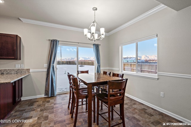 dining area with an inviting chandelier, crown molding, a healthy amount of sunlight, and a water view