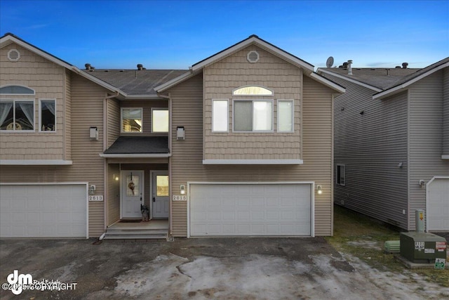 view of front of house with cooling unit and a garage