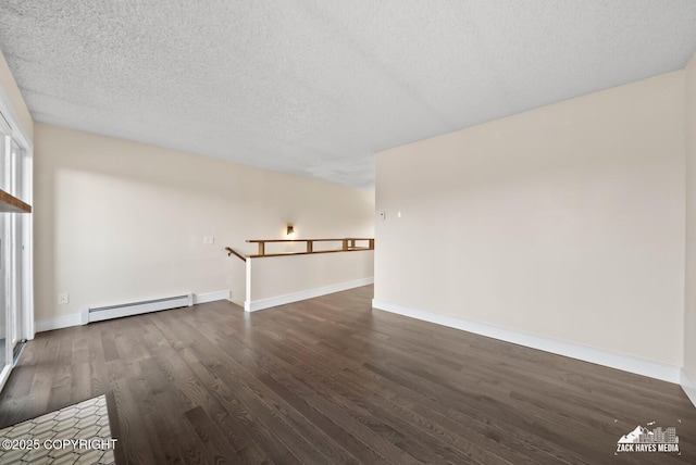 unfurnished living room featuring a baseboard heating unit, dark wood-type flooring, and a textured ceiling