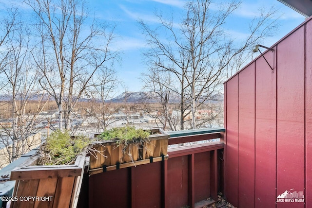 exterior space featuring a balcony and a mountain view