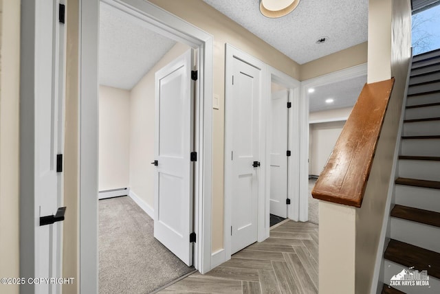 hall featuring a textured ceiling and a baseboard radiator