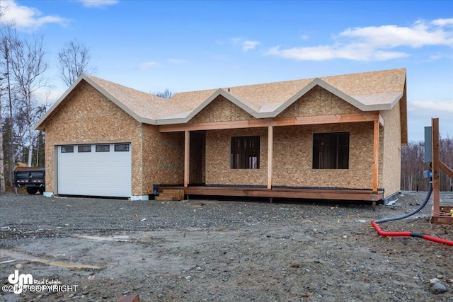 property under construction with a porch and a garage