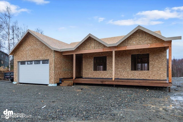 property under construction featuring a garage and covered porch