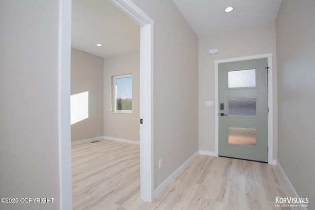 foyer entrance with light hardwood / wood-style flooring and a healthy amount of sunlight