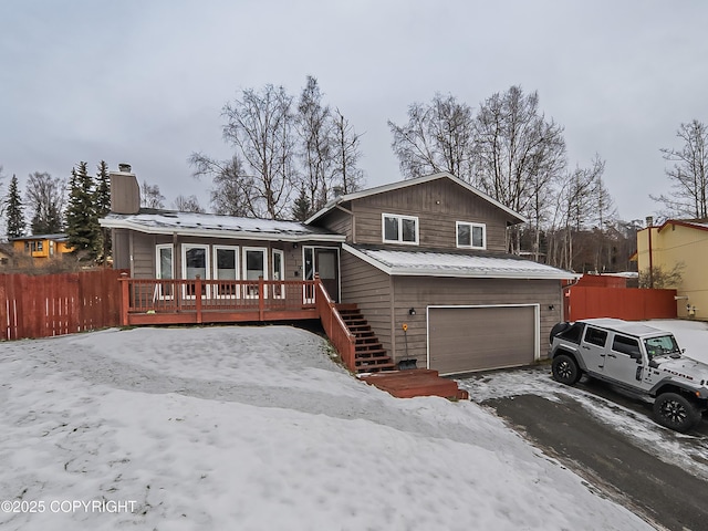 view of front of home with a deck and a garage