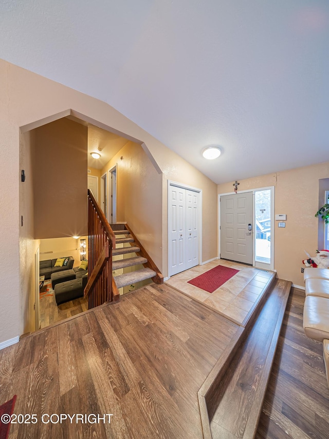 entrance foyer featuring lofted ceiling and hardwood / wood-style floors