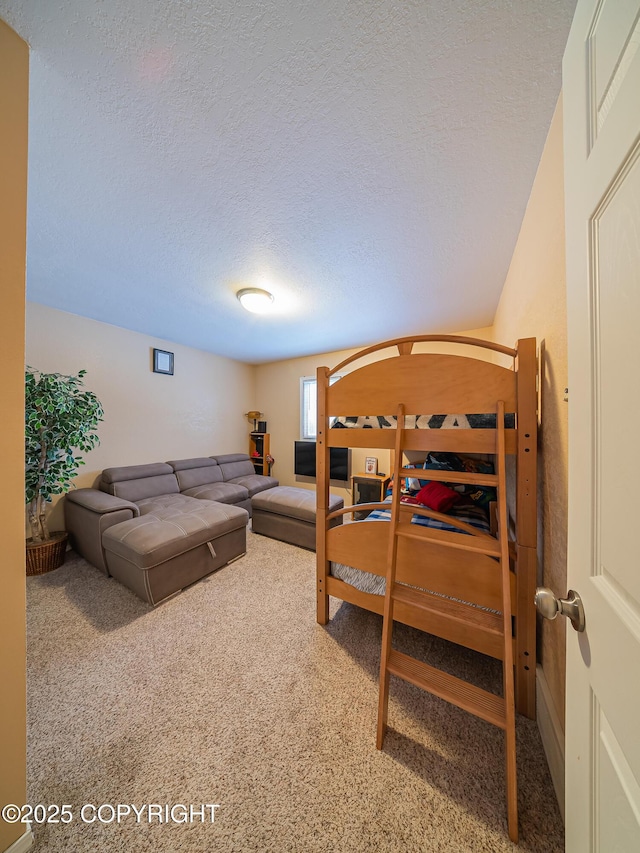 bedroom featuring carpet floors and a textured ceiling