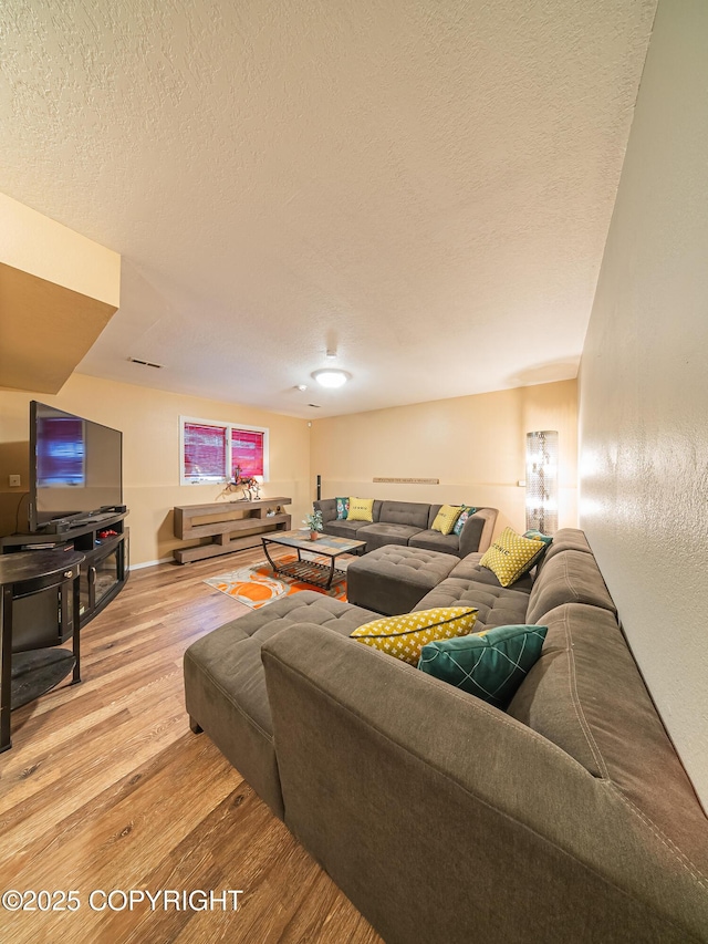 living room featuring hardwood / wood-style flooring and a textured ceiling