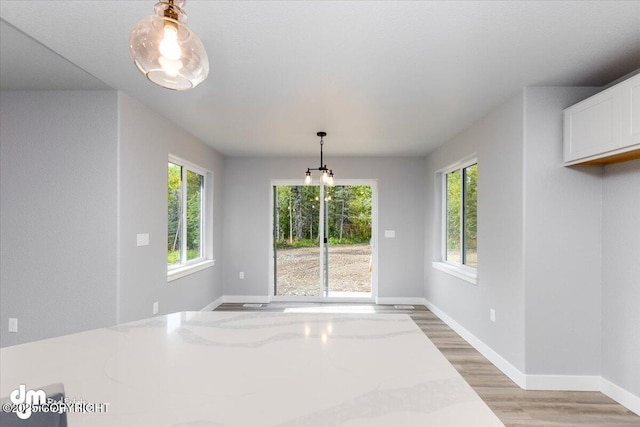 unfurnished dining area featuring a healthy amount of sunlight