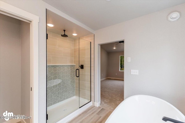 bathroom with hardwood / wood-style flooring and plus walk in shower