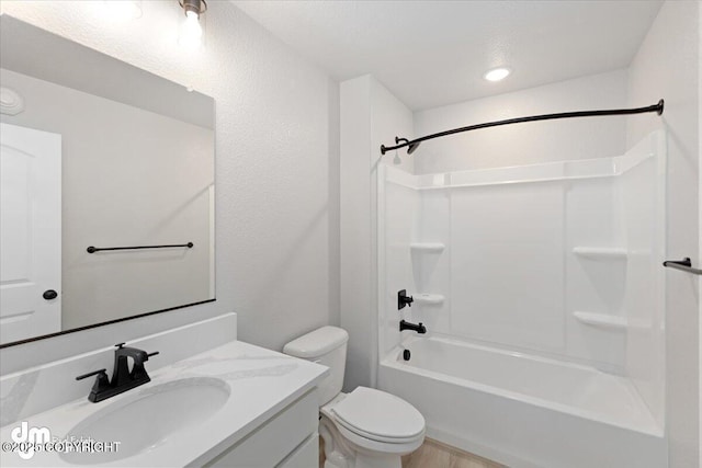 full bathroom with toilet, vanity, and shower / bath combination