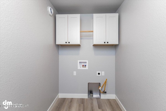 laundry area with electric dryer hookup, light wood-type flooring, hookup for a washing machine, and cabinets