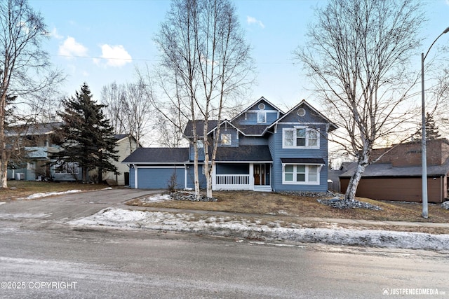 view of front of home with a porch and a garage