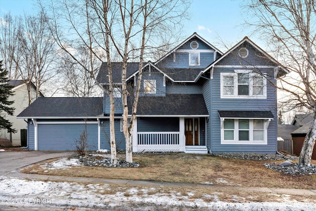 view of front of house with covered porch and a garage