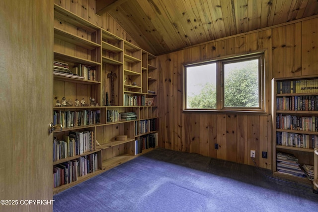 sitting room featuring wooden ceiling, vaulted ceiling, wood walls, and dark carpet