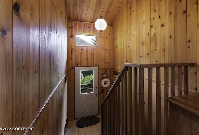 stairs featuring wooden walls and wood ceiling