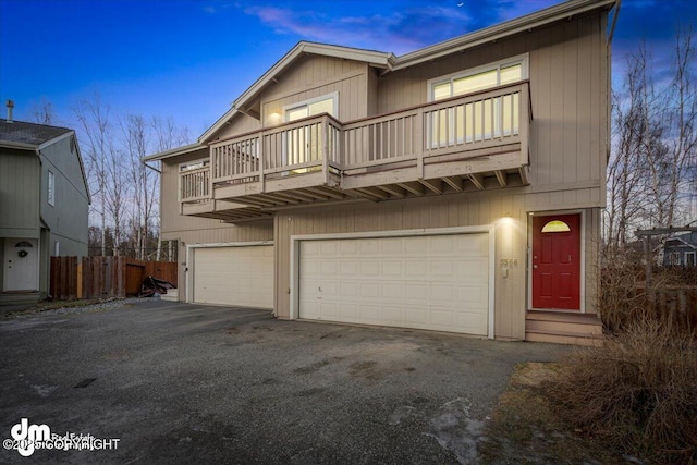 view of front facade featuring a balcony and a garage