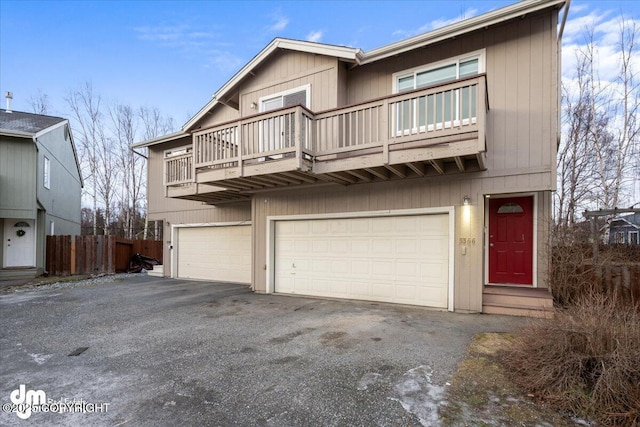 view of front facade featuring a balcony and a garage