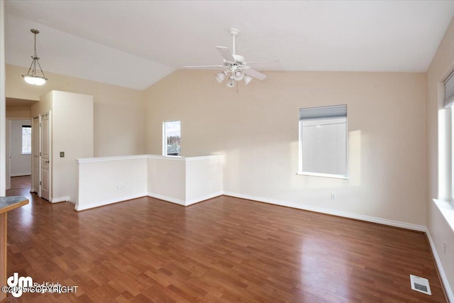 spare room featuring ceiling fan, vaulted ceiling, and dark hardwood / wood-style floors