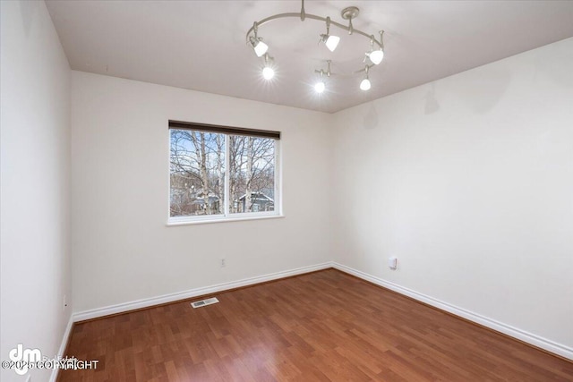 spare room with hardwood / wood-style flooring