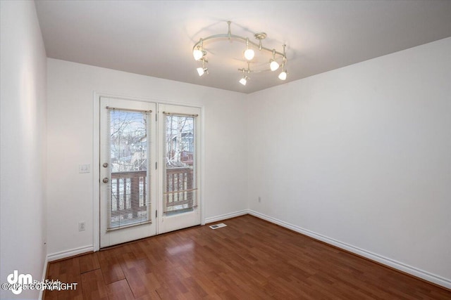 empty room with dark wood-type flooring