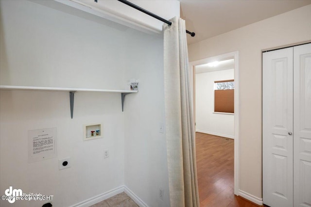 washroom with electric dryer hookup, hookup for a washing machine, and hardwood / wood-style floors