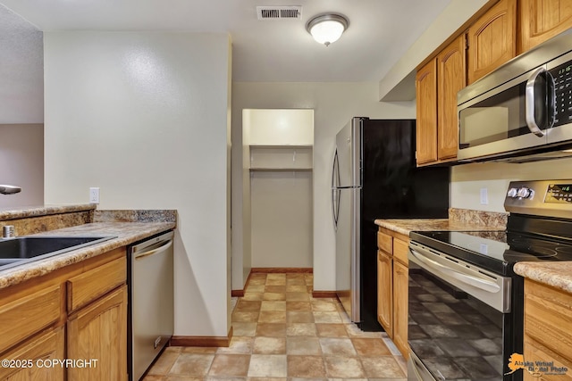 kitchen with appliances with stainless steel finishes and sink