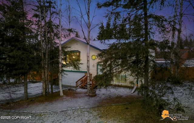 property exterior at dusk with a garage