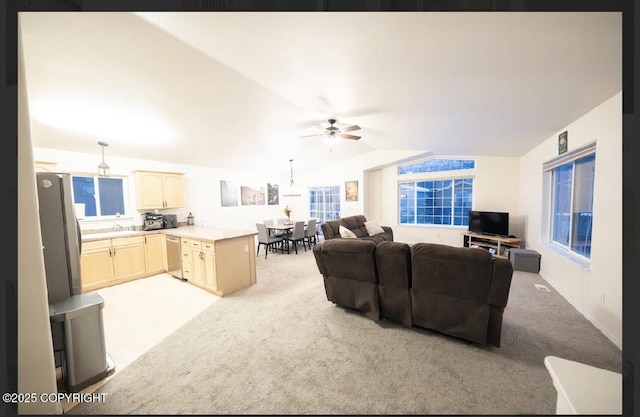 carpeted living room with vaulted ceiling and ceiling fan