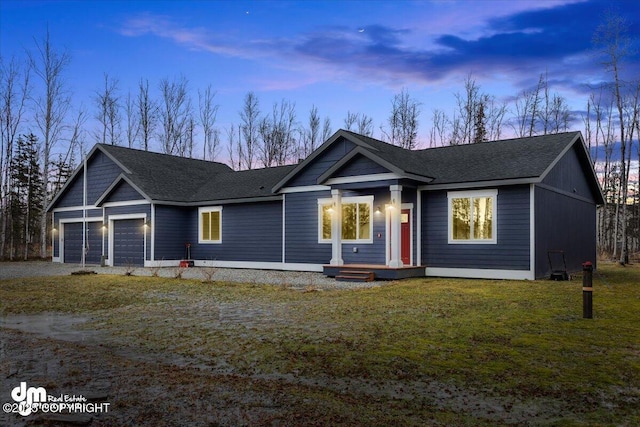 single story home with a garage and a yard