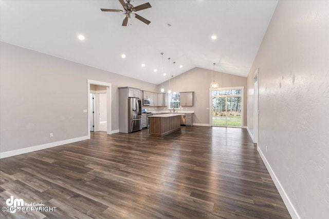 unfurnished living room with ceiling fan, dark hardwood / wood-style flooring, and high vaulted ceiling