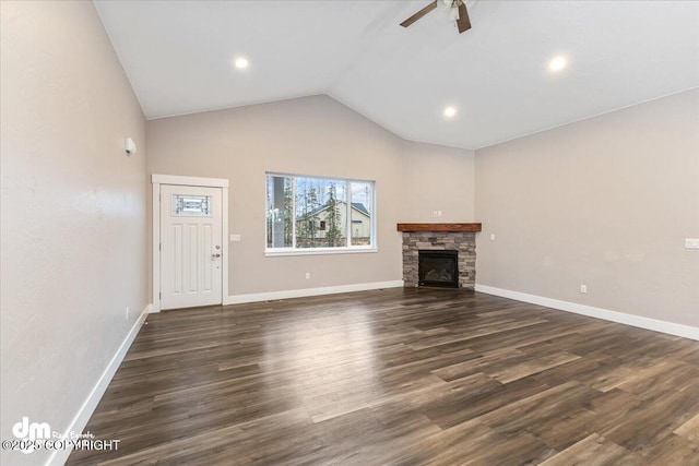 unfurnished living room featuring dark wood-type flooring, ceiling fan, a fireplace, and high vaulted ceiling