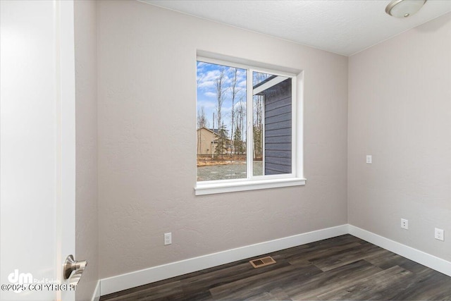 empty room featuring dark hardwood / wood-style flooring