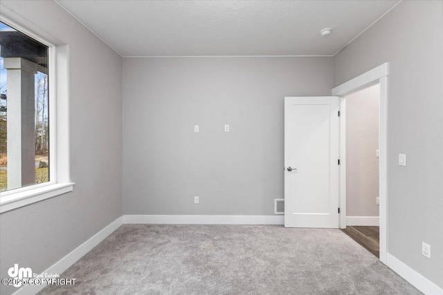 empty room featuring carpet floors