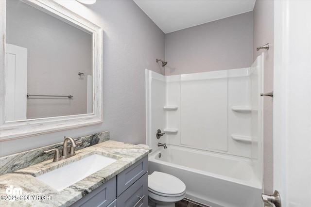 full bathroom featuring vanity, toilet, and  shower combination