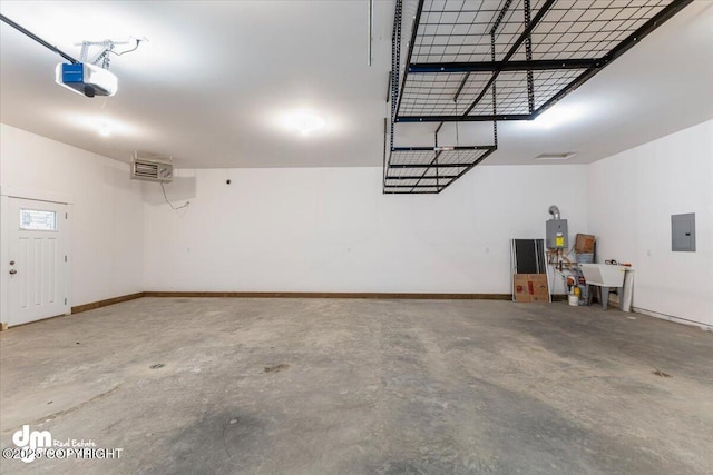 garage with a garage door opener, electric panel, and sink