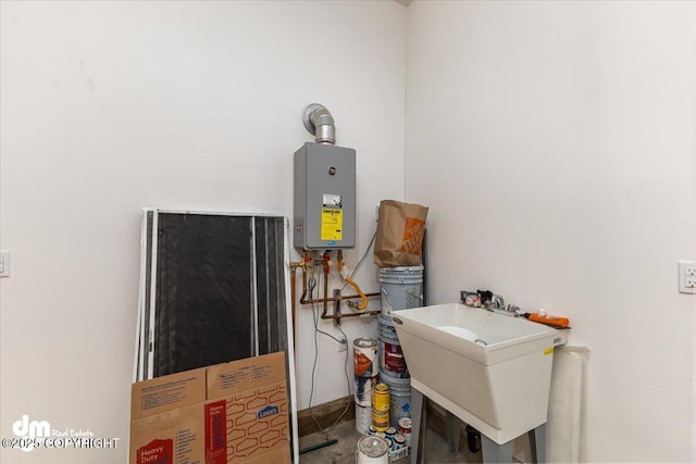 utility room featuring water heater and sink