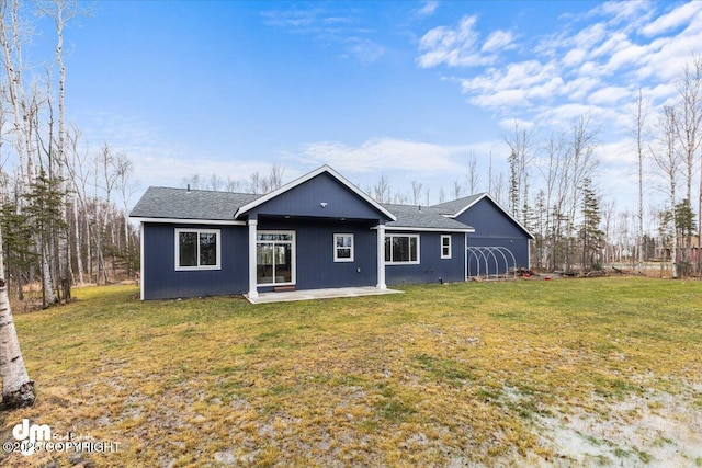 rear view of property with a yard and a patio area