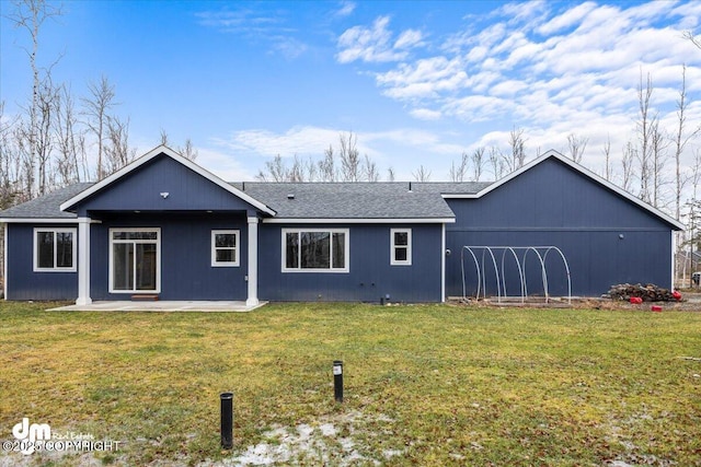 rear view of house featuring a patio and a lawn