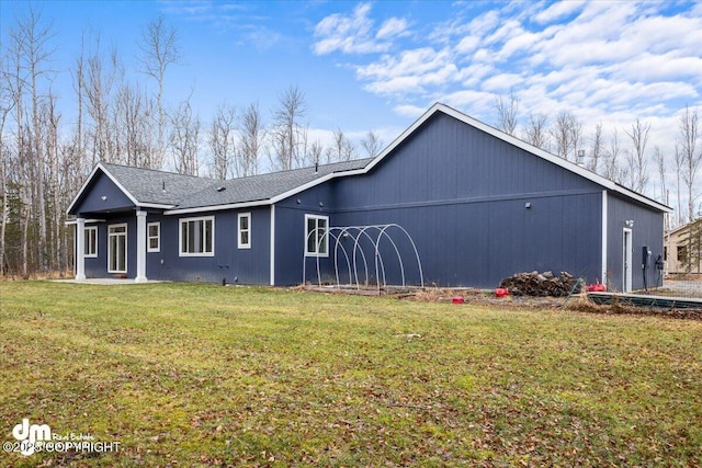 rear view of house with a yard