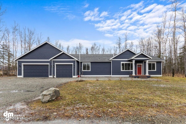 view of front of house with a garage and a front yard