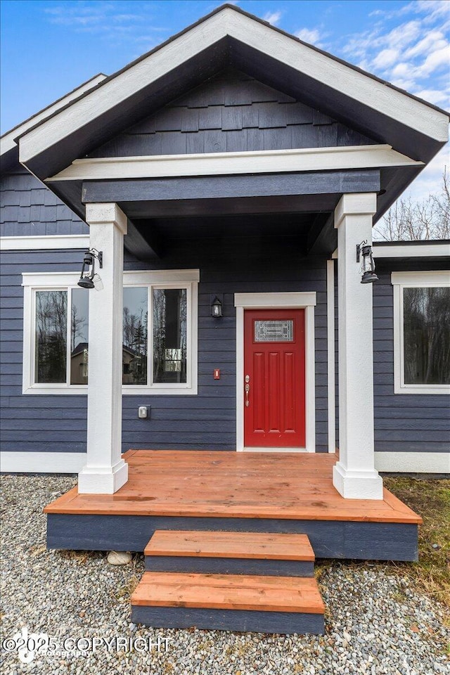 view of exterior entry featuring a porch