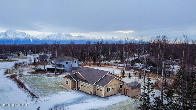 snowy aerial view featuring a mountain view