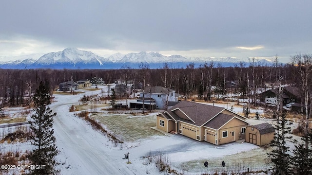 snowy aerial view with a mountain view