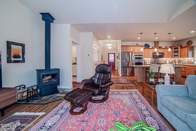 living room with a wood stove and dark hardwood / wood-style floors