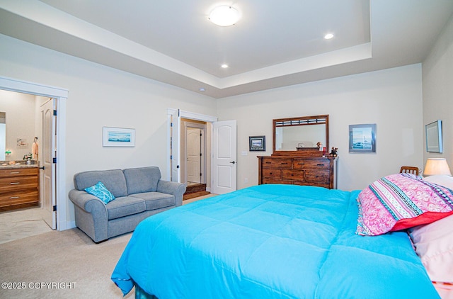 carpeted bedroom with a raised ceiling