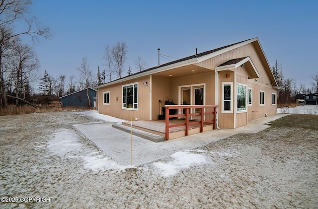 rear view of property with a wooden deck