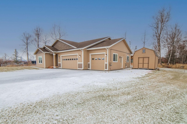 snow covered property featuring a shed