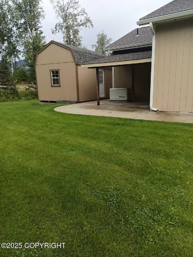 view of yard with a patio and a storage unit