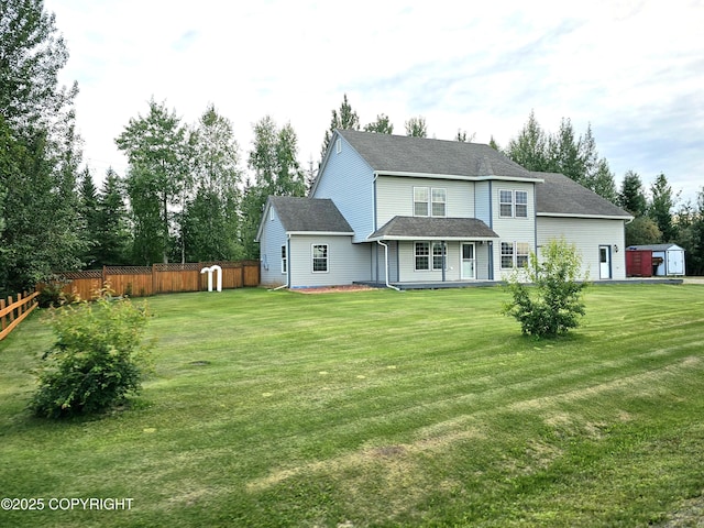 rear view of house with a yard